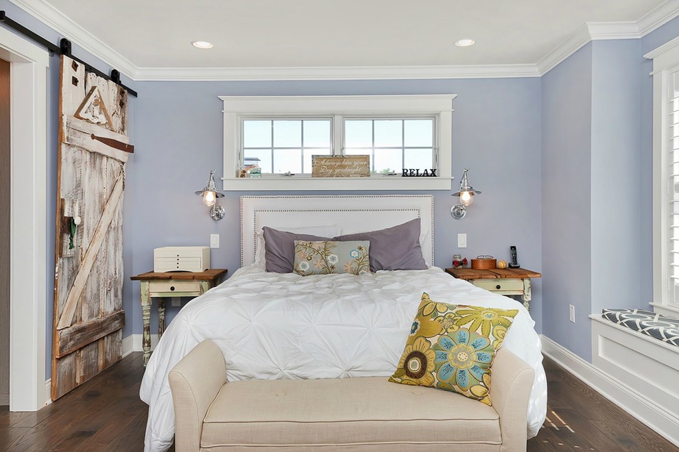 Design ideas for a mid-sized beach style master bedroom in New York with purple walls, medium hardwood floors and no fireplace.