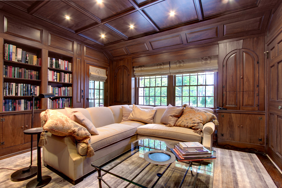This is an example of a mid-sized traditional enclosed family room in New York with a library and dark hardwood floors.