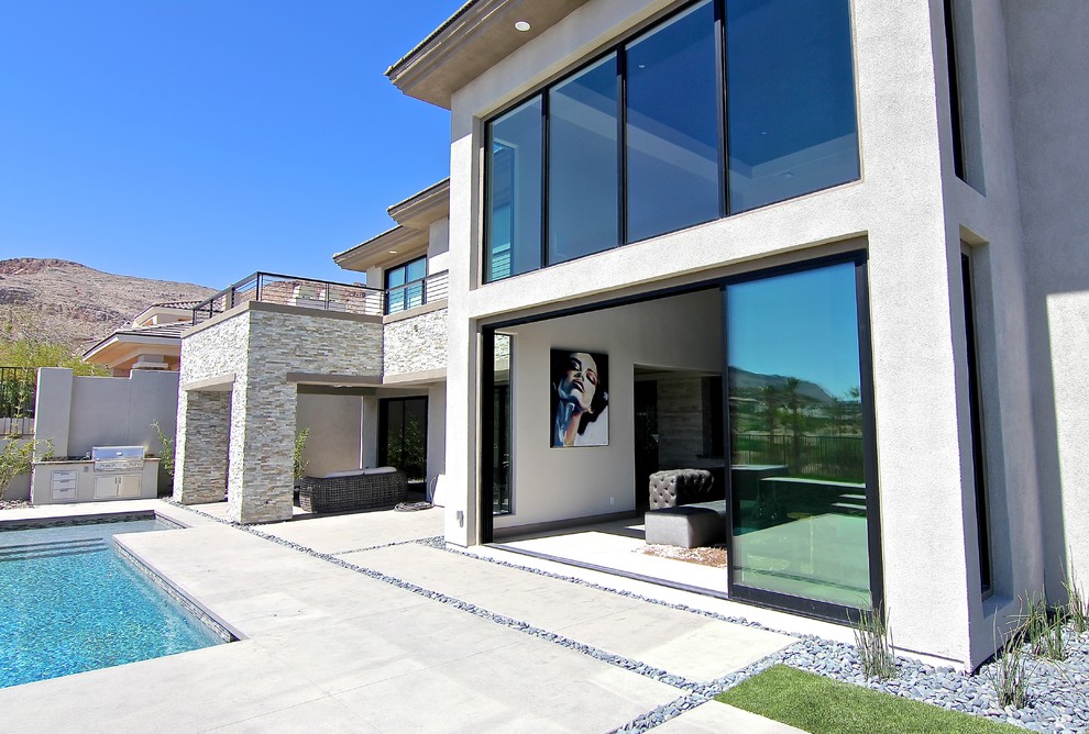 Photo of an expansive traditional two-storey stucco grey exterior in Las Vegas with a hip roof.