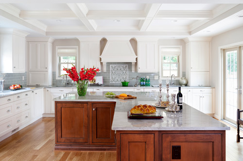 Bright, modern white kitchen with a coffered ceiling, marble island, and warm wood cabinetry accents—Kitchen Cabinet Mississauga.