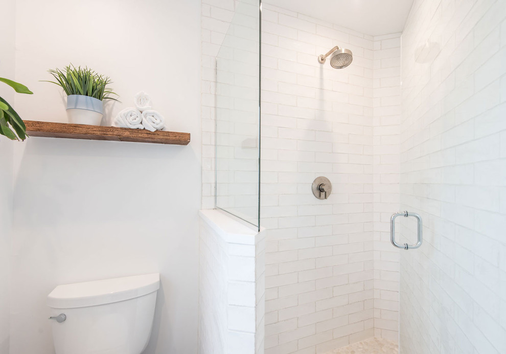 Inspiration for a mid-sized contemporary master bathroom in Chicago with an alcove shower, a one-piece toilet, white tile, subway tile, white walls, a vessel sink, a hinged shower door, concrete benchtops and white benchtops.
