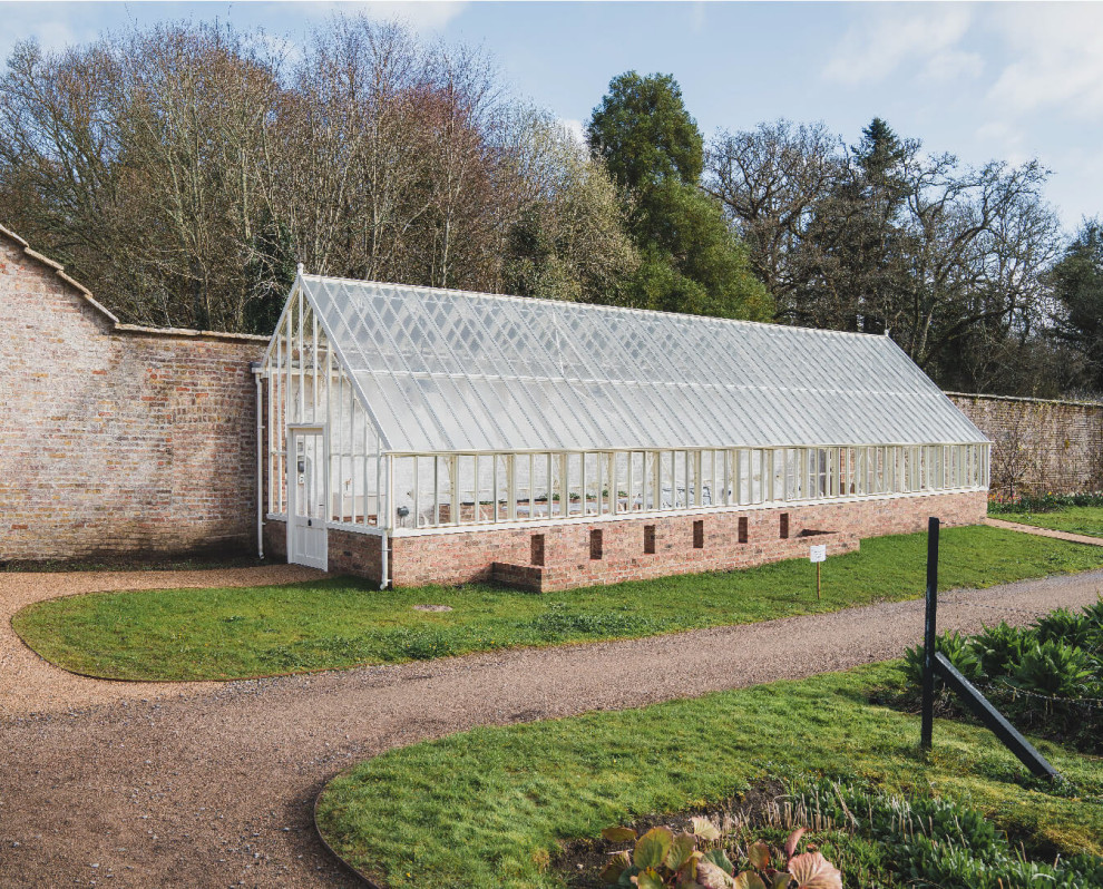 Large traditional attached greenhouse in Other.