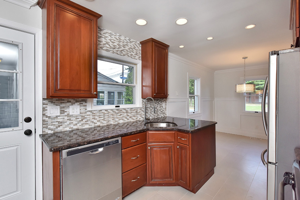 Kitchen - mid-sized transitional galley kitchen idea with a single-bowl sink, raised-panel cabinets, medium tone wood cabinets, gray backsplash, stainless steel appliances and no island