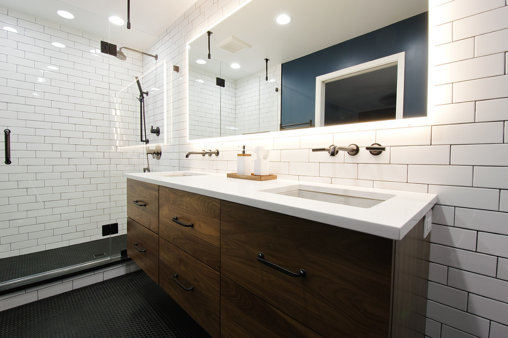 Alcove shower - mid-sized industrial master white tile and ceramic tile ceramic tile and black floor alcove shower idea in Chicago with flat-panel cabinets, brown cabinets, a one-piece toilet, blue walls, an undermount sink and quartz countertops