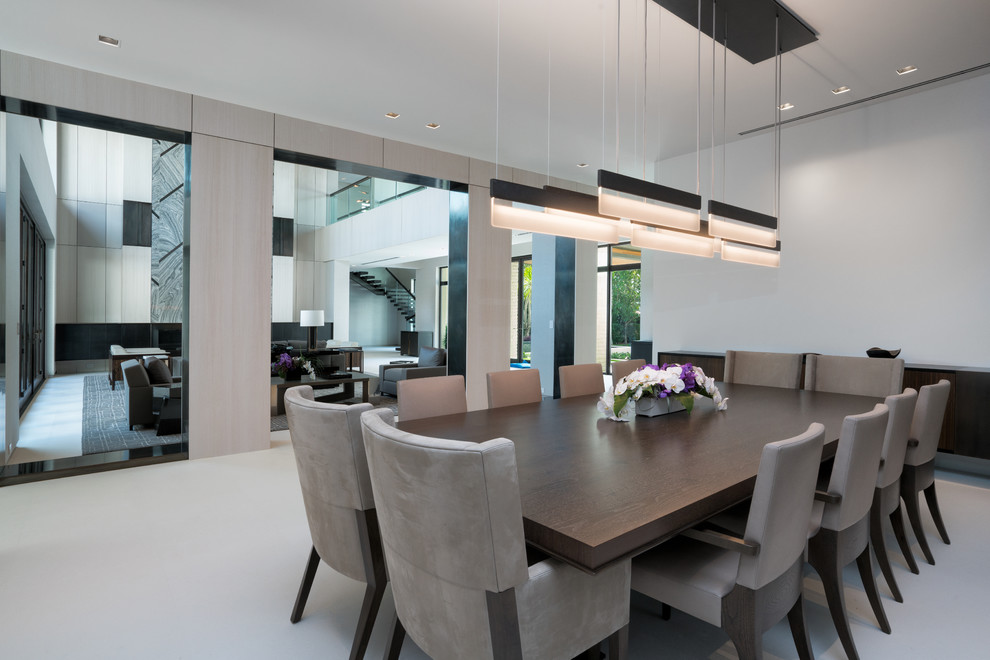 This is an example of a large contemporary kitchen/dining combo in Miami with white walls, travertine floors and white floor.