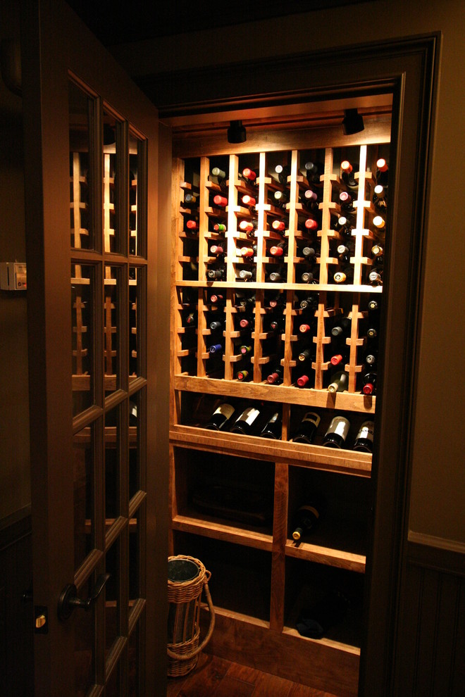 Inspiration for a small country wine cellar in Atlanta with medium hardwood floors, storage racks and brown floor.