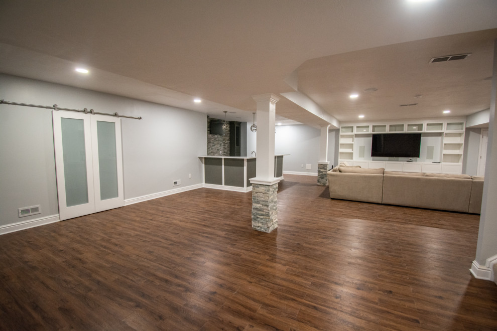 This is an example of a traditional basement in Other with grey walls.