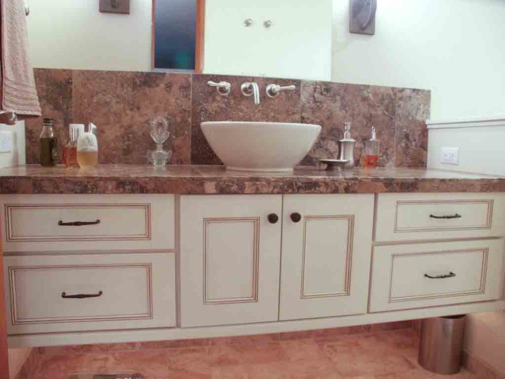 Mid-sized transitional master brown tile and ceramic tile porcelain tile freestanding bathtub photo with a vessel sink, recessed-panel cabinets, medium tone wood cabinets, granite countertops, a two-piece toilet and gray walls