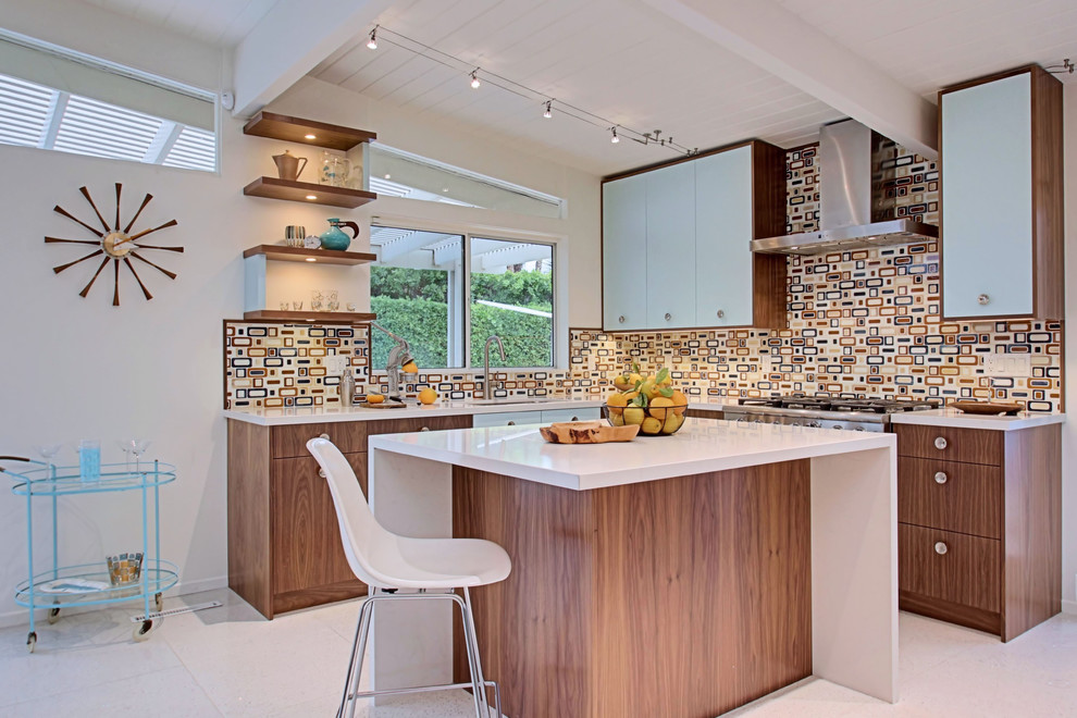 Design ideas for a midcentury l-shaped kitchen in Vancouver with an undermount sink, flat-panel cabinets, quartz benchtops, multi-coloured splashback, stainless steel appliances, travertine floors and with island.