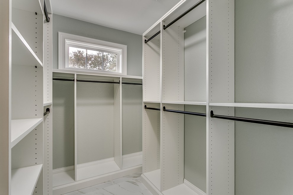 Photo of a mid-sized traditional gender-neutral walk-in wardrobe in Other with open cabinets, white cabinets and porcelain floors.