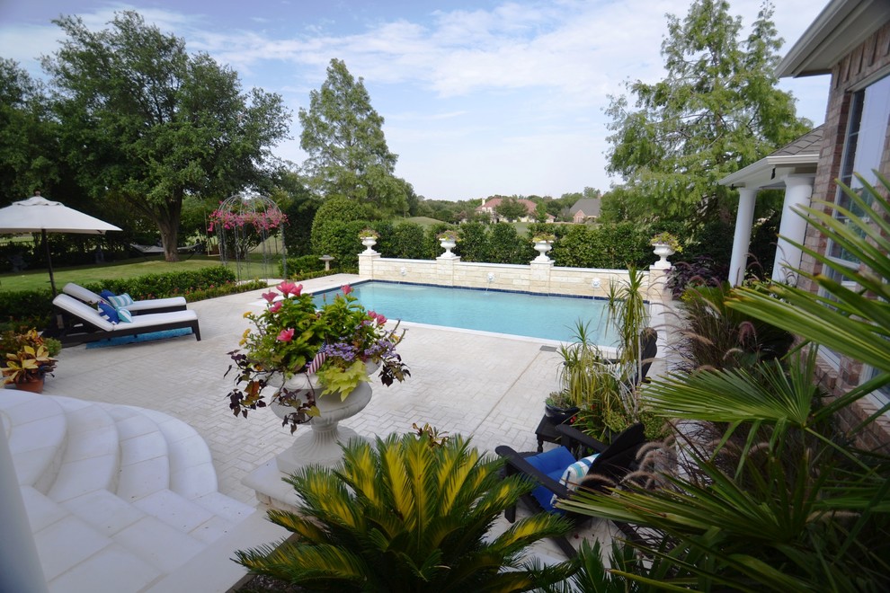 Example of a mid-sized backyard rectangular pool design in Dallas