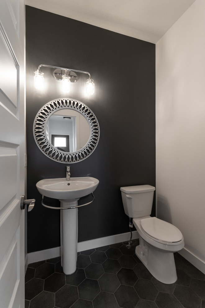 Design ideas for a mid-sized modern powder room in Other with a one-piece toilet, black walls, a pedestal sink and grey floor.