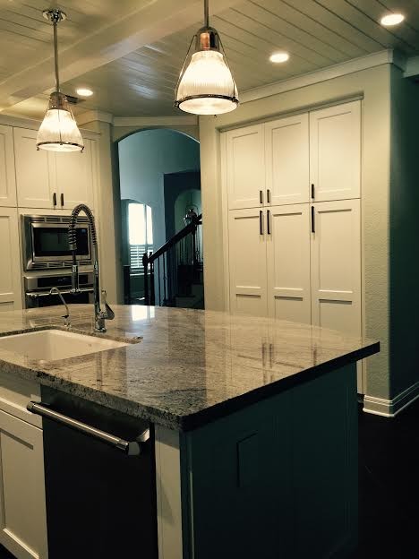 Large arts and crafts porcelain tile kitchen photo in Austin with shaker cabinets, white cabinets, granite countertops, white backsplash, subway tile backsplash and stainless steel appliances