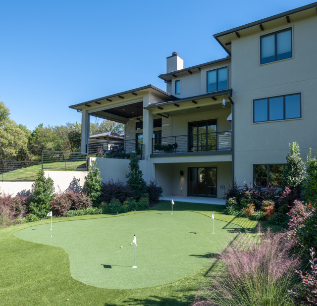 Backyard with putting green transitional-garden