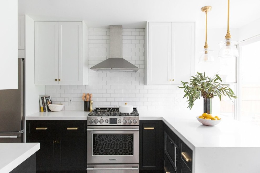 Mid-sized transitional l-shaped kitchen in Salt Lake City with white splashback, subway tile splashback, stainless steel appliances, shaker cabinets and a peninsula.