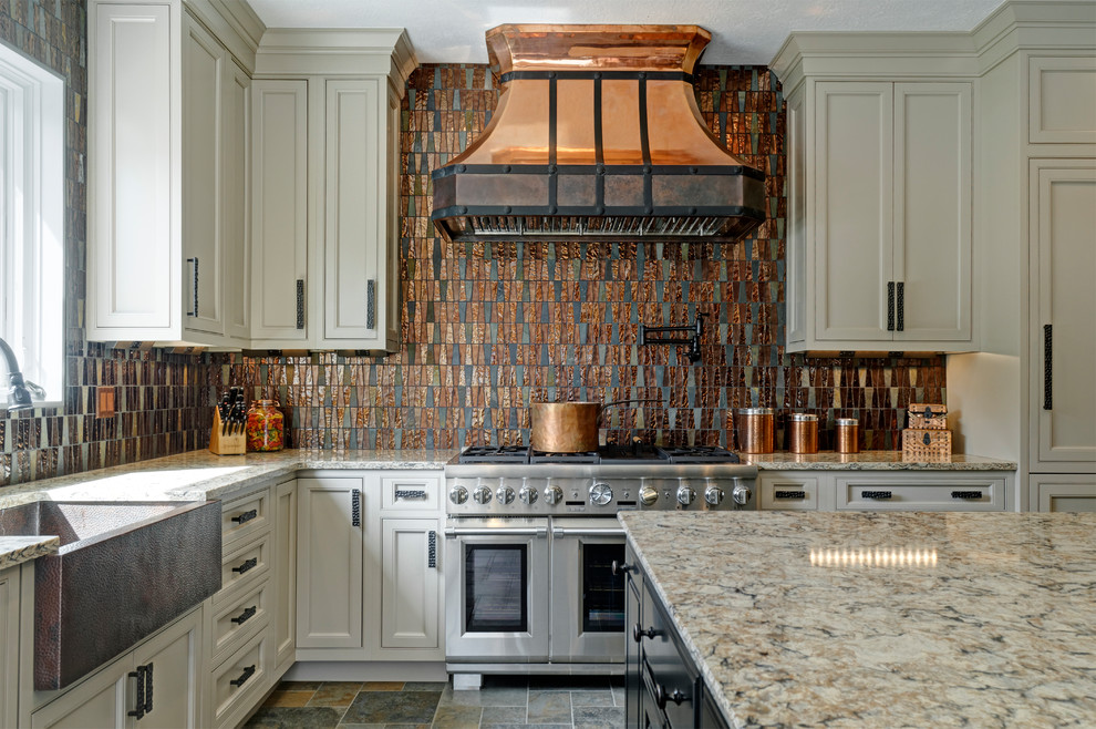 Inspiration for a large traditional l-shaped eat-in kitchen in Columbus with a farmhouse sink, recessed-panel cabinets, white cabinets, quartzite benchtops, metallic splashback, glass sheet splashback, stainless steel appliances, ceramic floors, with island, multi-coloured floor and beige benchtop.