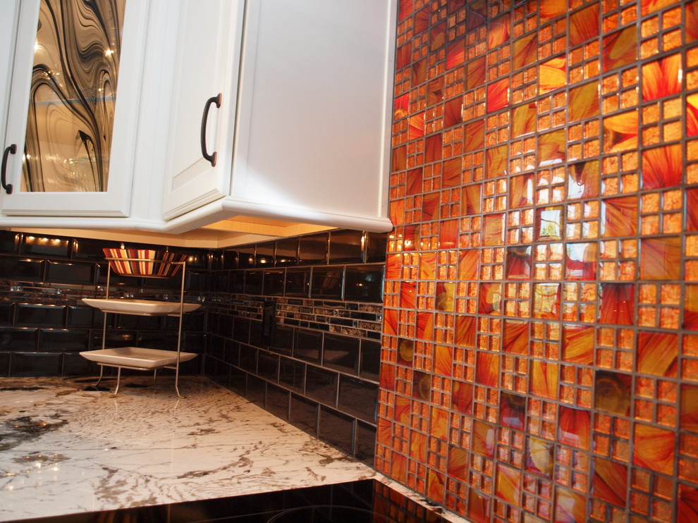 Eat-in kitchen - large transitional medium tone wood floor eat-in kitchen idea in Philadelphia with an undermount sink, raised-panel cabinets, white cabinets, granite countertops, black backsplash, ceramic backsplash, stainless steel appliances and an island
