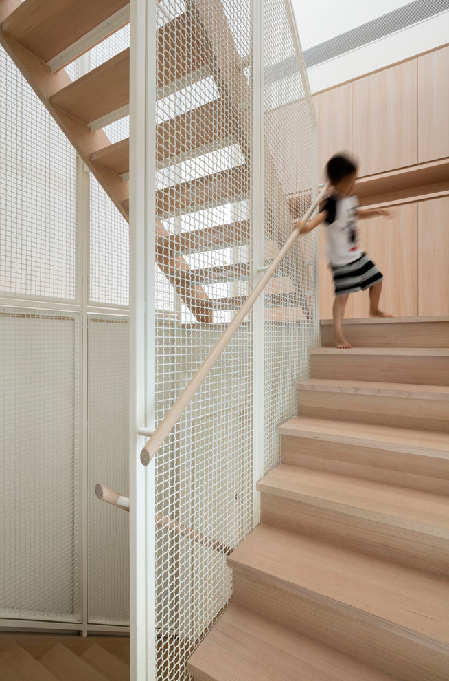 This is an example of a mid-sized contemporary wood staircase in Melbourne with wood risers.