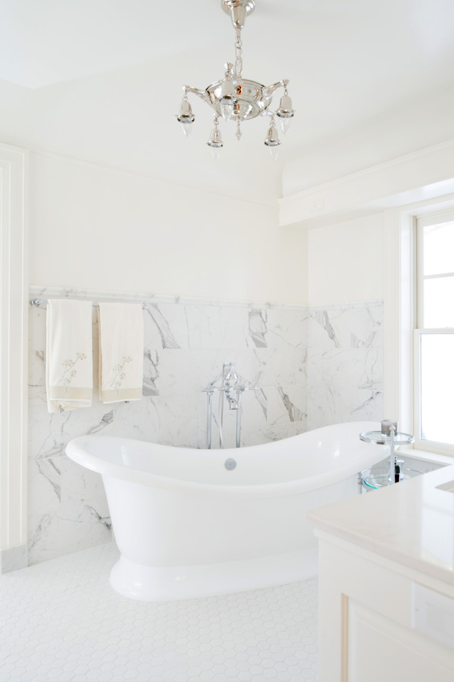 Inspiration for a mid-sized traditional master bathroom in Kansas City with furniture-like cabinets, white cabinets, marble benchtops, a freestanding tub, an alcove shower, white tile, porcelain tile, white walls and porcelain floors.