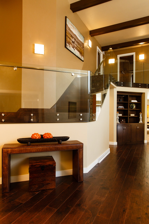 Large transitional medium tone wood floor and brown floor foyer photo with yellow walls
