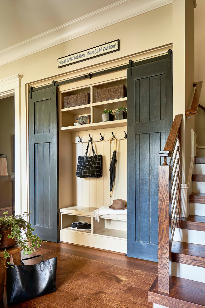 Design ideas for a country mudroom in Raleigh with beige walls and medium hardwood floors.