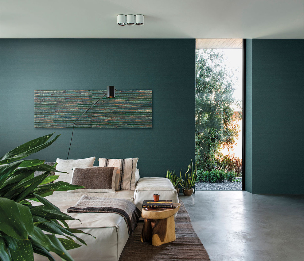 Photo of a large contemporary master bedroom in Hamburg with green walls, concrete floors and grey floor.