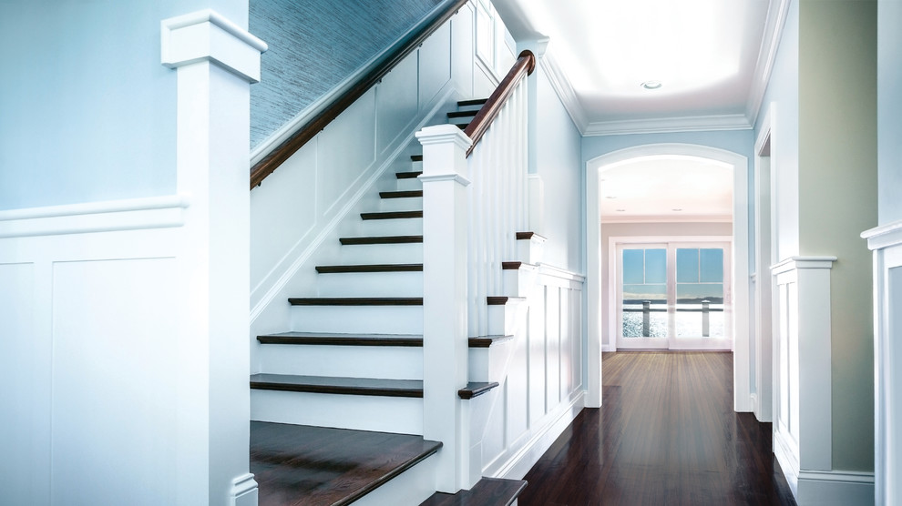 Large beach style wood l-shaped staircase in Boston with wood risers.