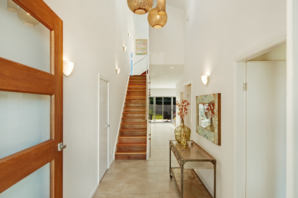 Design ideas for a beach style wood l-shaped staircase in Central Coast with wood risers and metal railing.