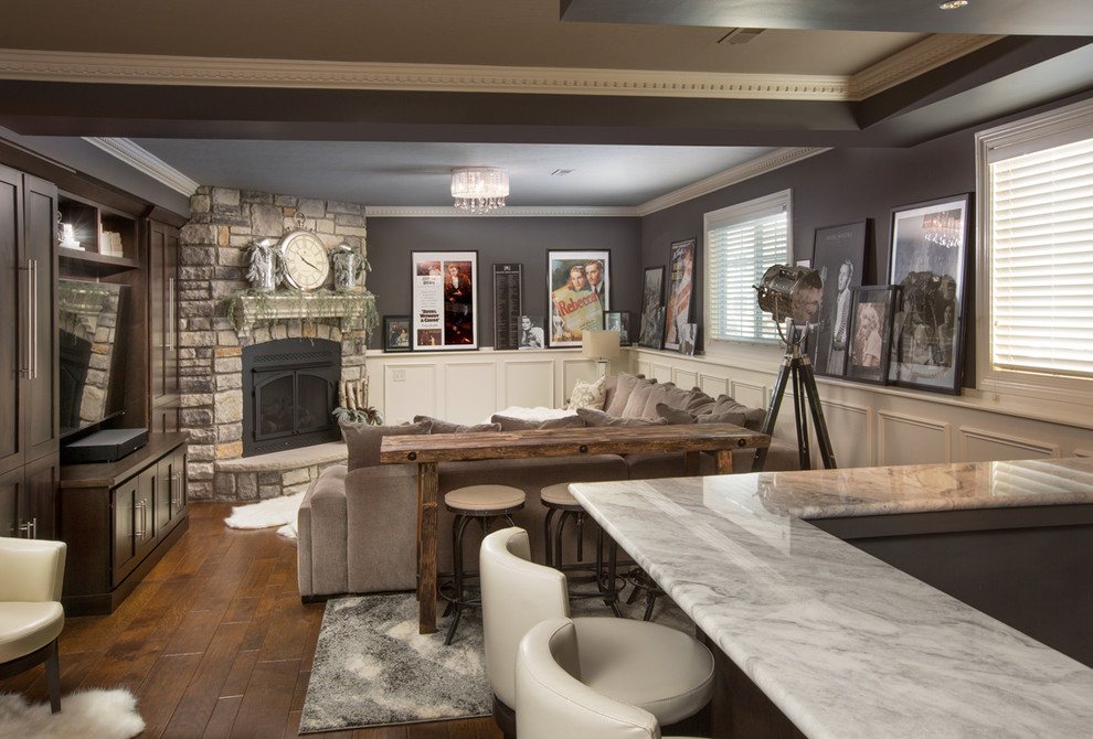 Example of a mountain style basement design in Cincinnati with gray walls, a standard fireplace and a stone fireplace