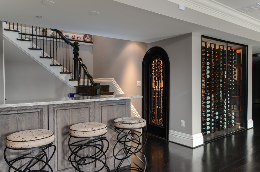Design ideas for a large traditional wine cellar in Baltimore with dark hardwood floors and display racks.