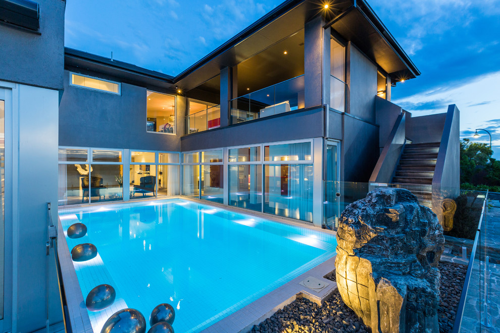 This is an example of a contemporary courtyard rectangular pool in Melbourne.