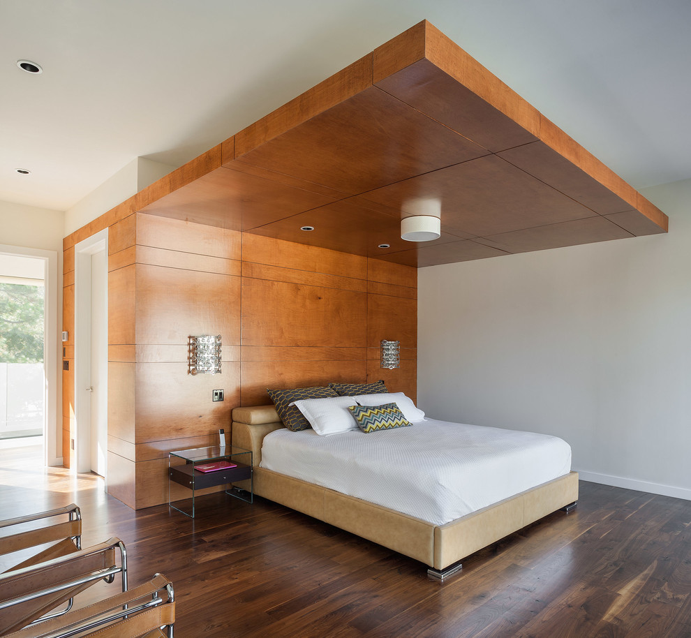 Inspiration for a contemporary bedroom in Houston with dark hardwood floors.
