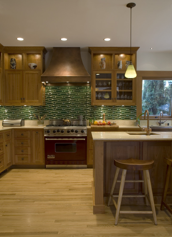 This is an example of a traditional kitchen in San Francisco with shaker cabinets, medium wood cabinets, green splashback and coloured appliances.