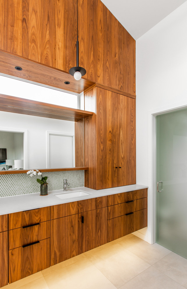 This is an example of a large midcentury master wet room bathroom in Seattle with flat-panel cabinets, an undermount tub, a one-piece toilet, green tile, ceramic tile, white walls, porcelain floors, an undermount sink, engineered quartz benchtops, grey floor, a hinged shower door, white benchtops, an enclosed toilet, a double vanity, a floating vanity and vaulted.