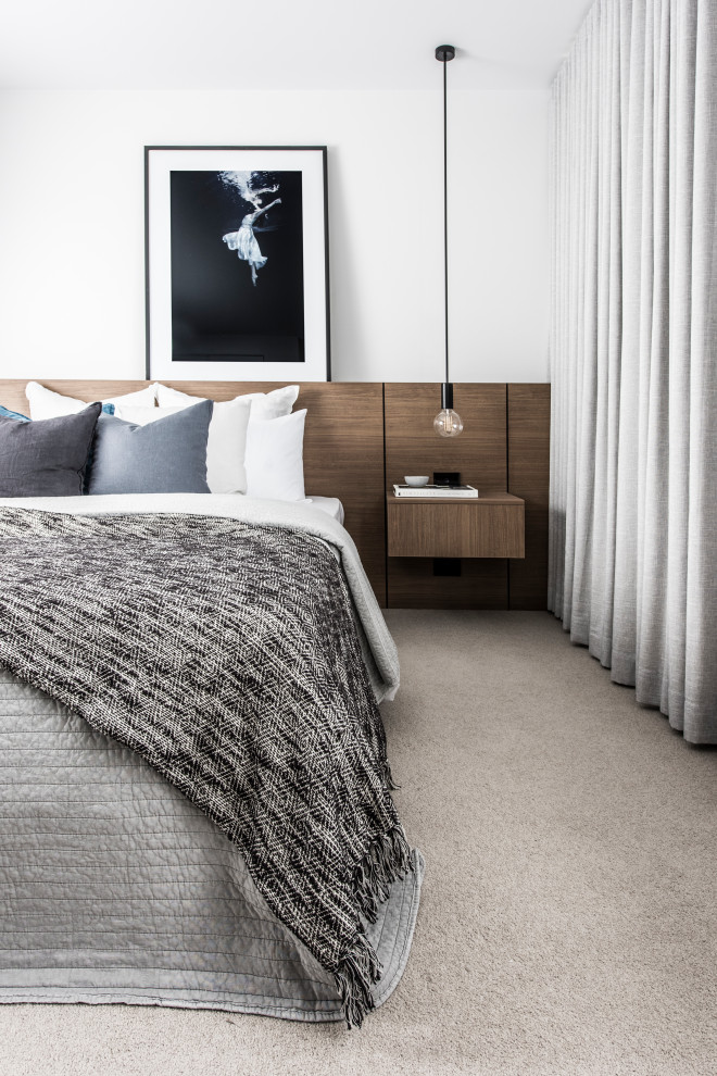 Inspiration for a mid-sized contemporary master bedroom in Sydney with white walls, carpet and beige floor.
