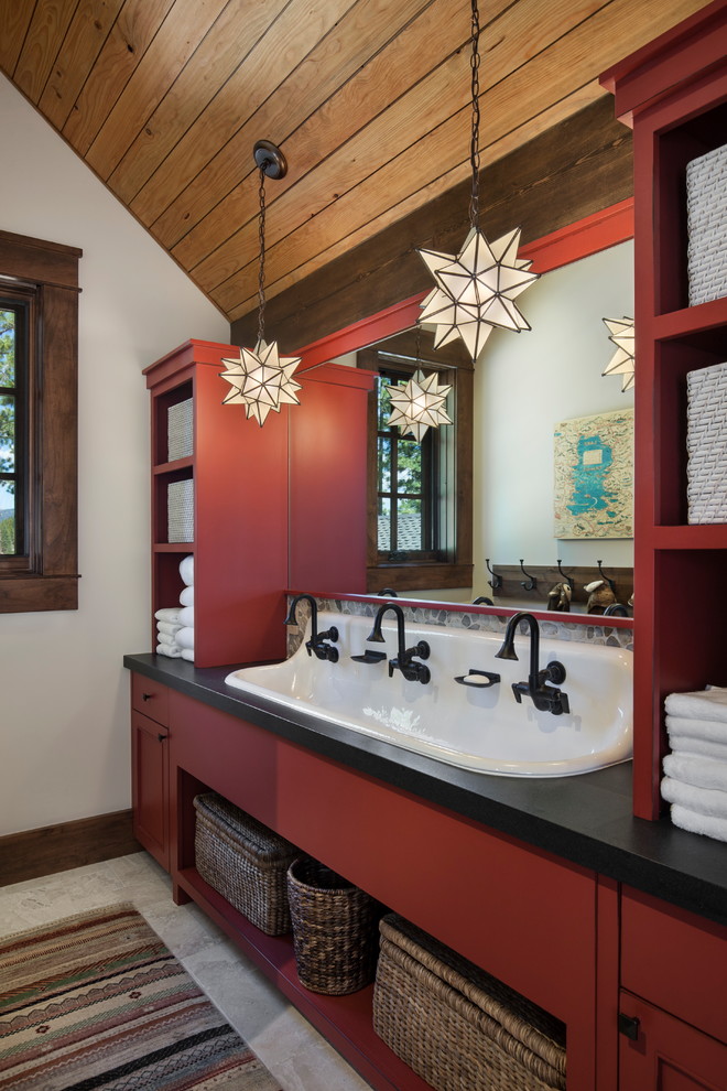 Photo of a country kids bathroom in Sacramento with open cabinets, red cabinets, white walls, a trough sink, grey floor, black benchtops, pebble tile and granite benchtops.
