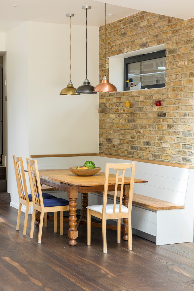 Inspiration for a contemporary open plan dining in London with white walls, dark hardwood floors and brown floor.