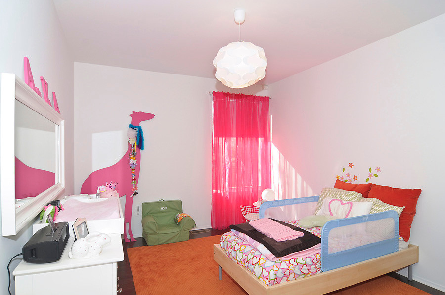 Design ideas for a mid-sized transitional kids' room for girls in DC Metro with white walls and dark hardwood floors.