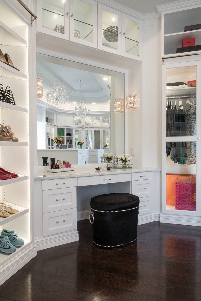 Inspiration for a large traditional women's walk-in wardrobe in St Louis with white cabinets, dark hardwood floors and recessed-panel cabinets.