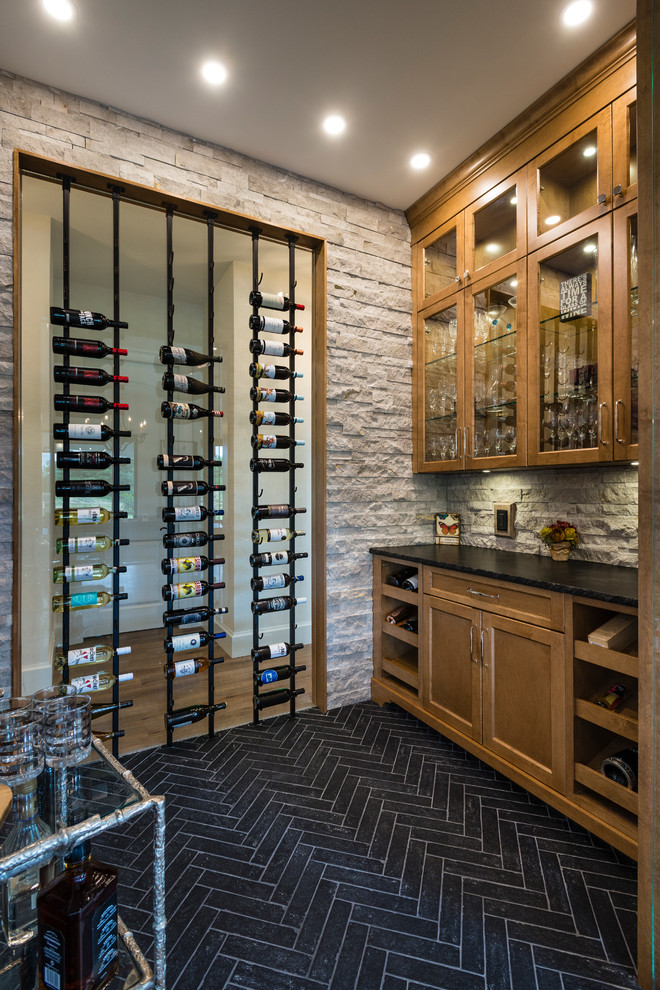 Photo of a large transitional wine cellar in Vancouver with porcelain floors, storage racks and black floor.