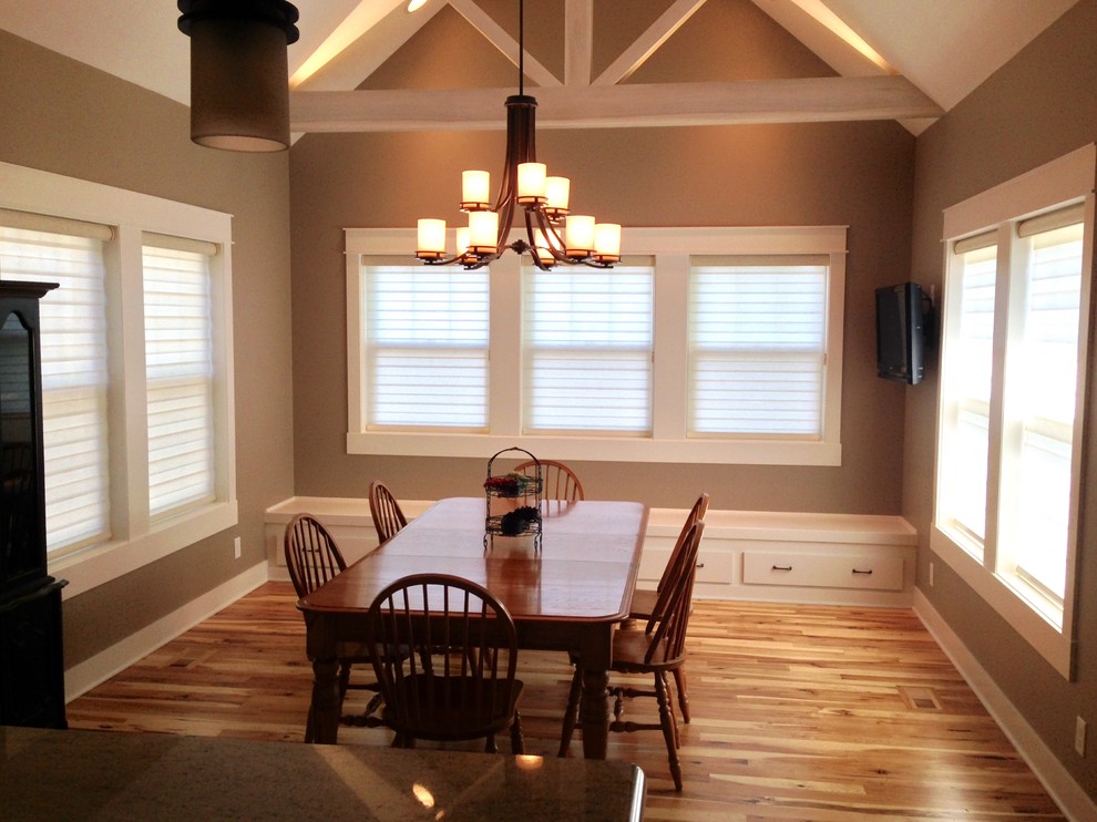 Inspiration for a small contemporary light wood floor and beige floor great room remodel with brown walls and no fireplace