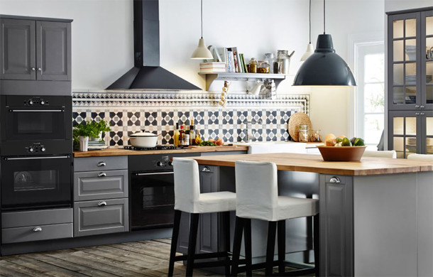 Mid-sized transitional dark wood floor and brown floor kitchen photo with a farmhouse sink, raised-panel cabinets, gray cabinets, wood countertops, multicolored backsplash, ceramic backsplash and an island