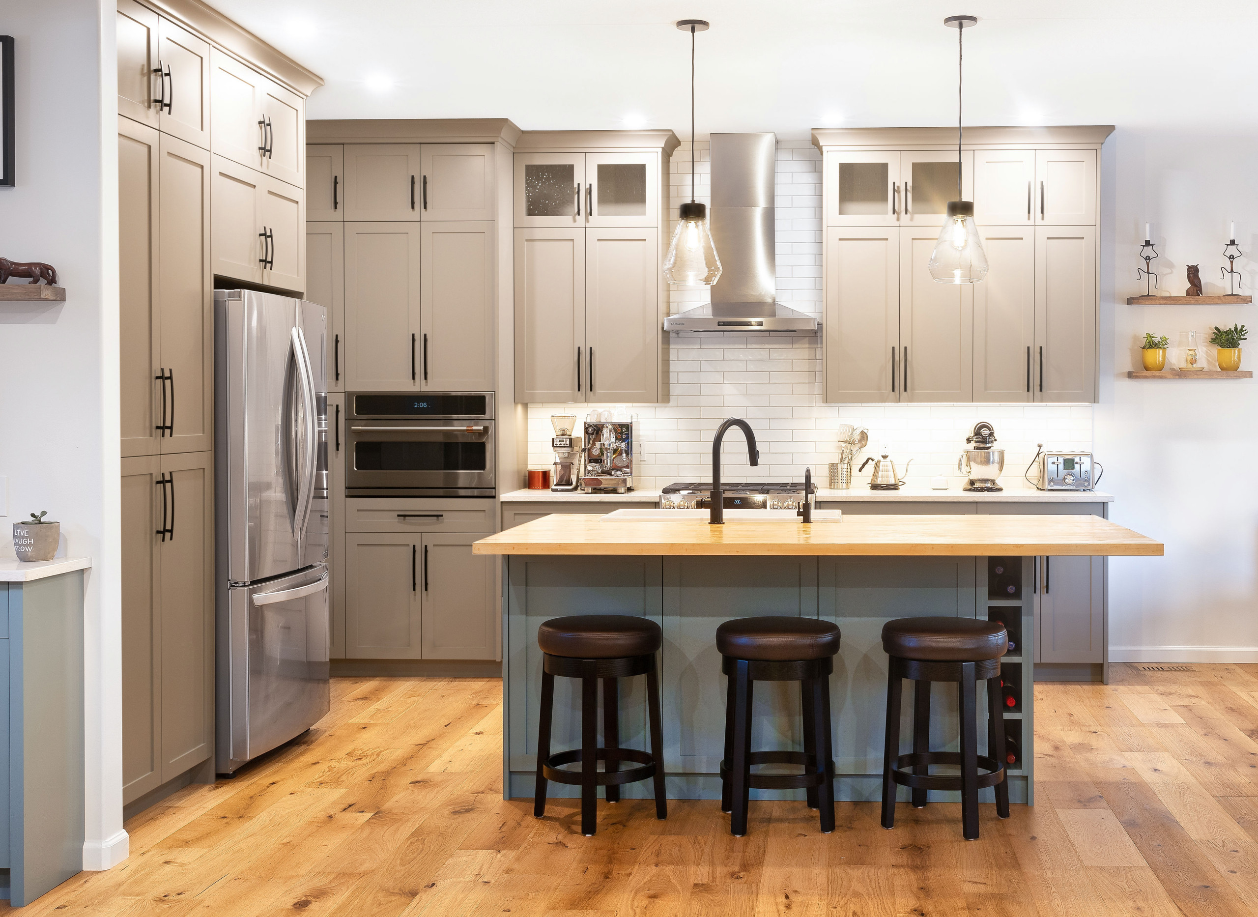 Kitchen photo in Calgary with a farmhouse sink, shaker cabinets, wood countertops and an island