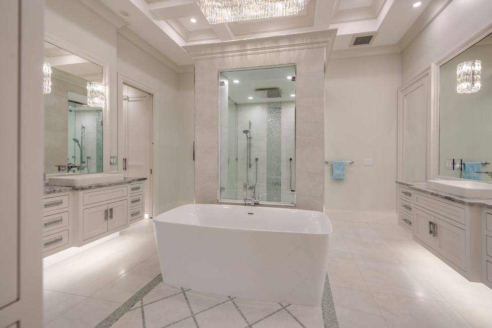Freestanding bathtub - transitional master white tile and porcelain tile porcelain tile, white floor, double-sink and coffered ceiling freestanding bathtub idea with beaded inset cabinets, white cabinets, a two-piece toilet, white walls, a vessel sink, quartzite countertops, a hinged shower door, gray countertops and a floating vanity