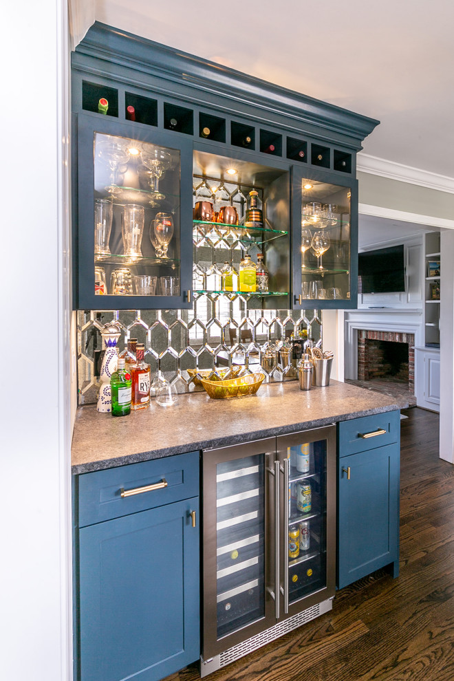 Large transitional kitchen pantry in Baltimore with a farmhouse sink, shaker cabinets, white cabinets, quartz benchtops, beige splashback, ceramic splashback, stainless steel appliances, medium hardwood floors, with island and brown floor.