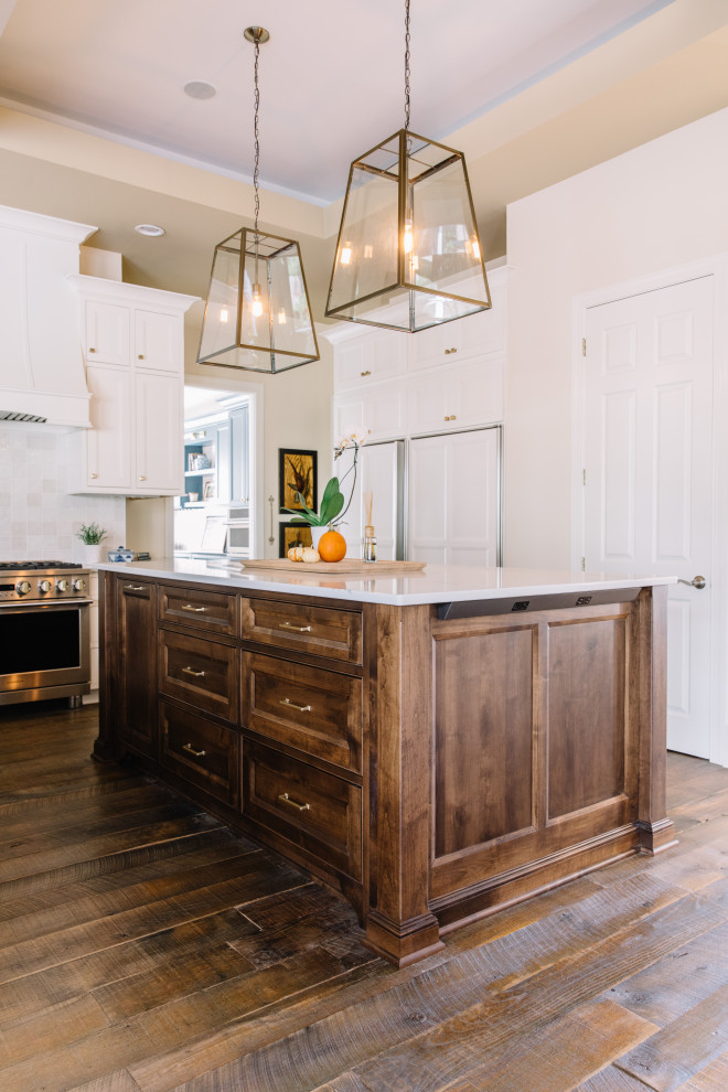 Example of a large classic u-shaped dark wood floor and brown floor open concept kitchen design in Other with an undermount sink, recessed-panel cabinets, beige cabinets, quartz countertops, white backsplash, ceramic backsplash, white appliances, an island and white countertops