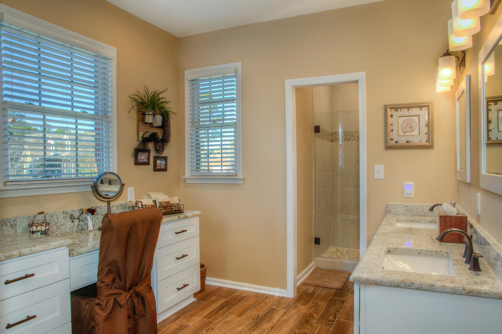 Large transitional master bathroom in Other with shaker cabinets, white cabinets, an alcove shower, beige tile, medium hardwood floors, an undermount sink, granite benchtops, ceramic tile and yellow walls.