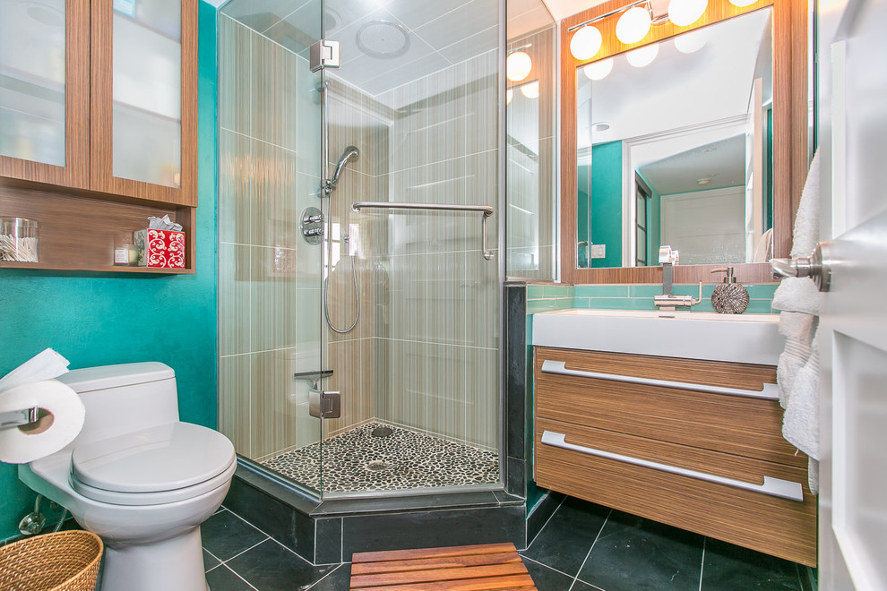 Photo of a small contemporary 3/4 bathroom in Toronto with a console sink, flat-panel cabinets, medium wood cabinets, a corner shower, a one-piece toilet, beige tile, ceramic tile, blue walls and slate floors.