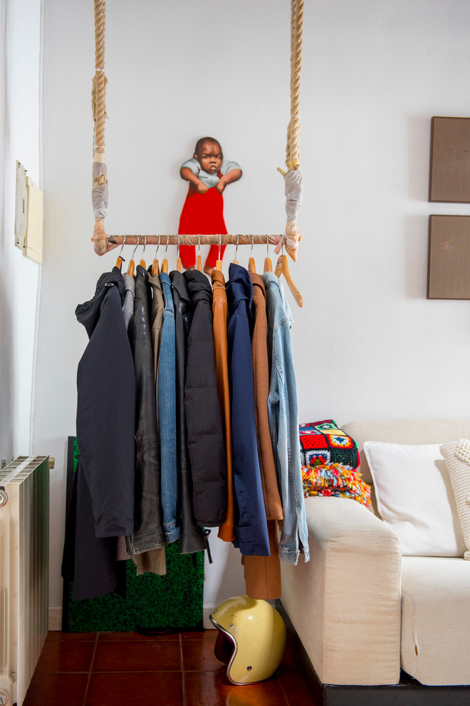 Inspiration for a small mediterranean gender-neutral storage and wardrobe in Madrid with open cabinets.