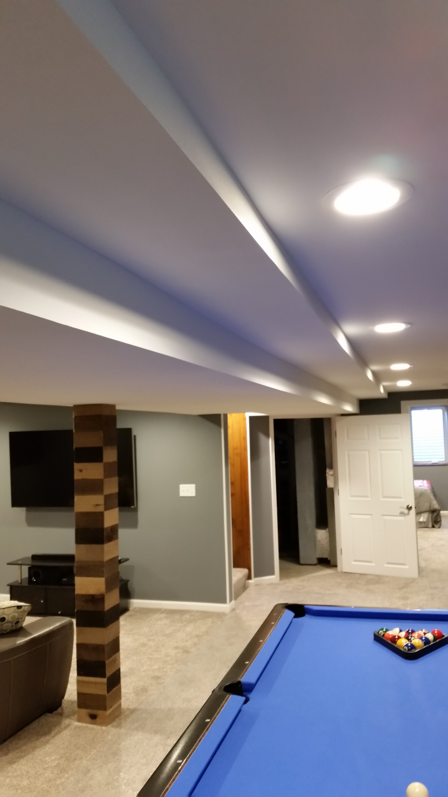 Basement rec room with custom bar and bedroom